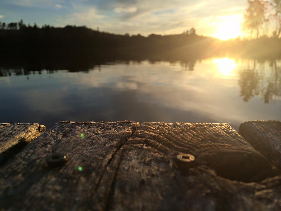 Sunset on the lake. Close up of dock wood.