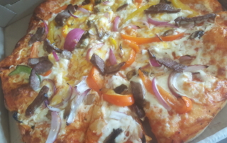 Pizza with onions and peppers