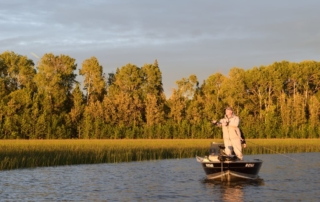Man Fishing at Dusk in a boat