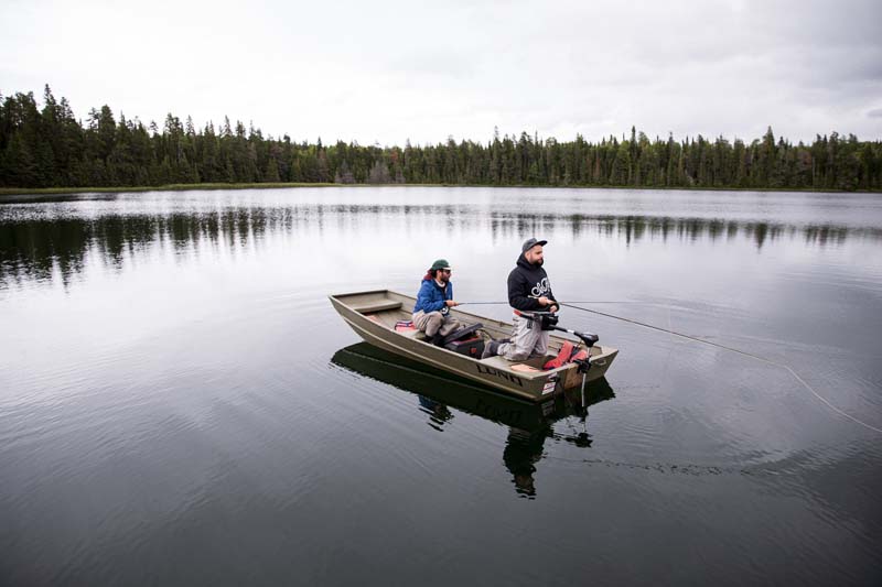 Two men fishing in a boat.