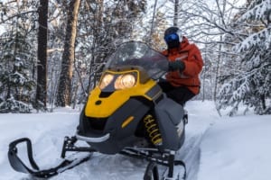 Snowmobiler posing on winter trail